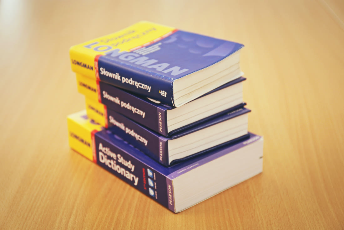 A stack of reference dictionaries, illustrating specialized translation